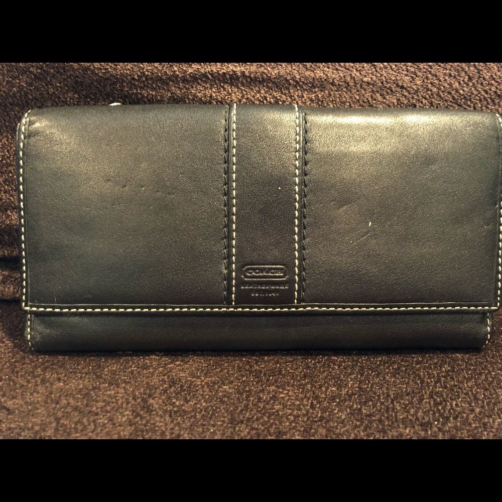 Black Coach wallet with purple inside.